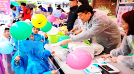 완주 와일드푸드축제를 방문한 어린아이들이 '아름다운 선거, 행복한 대한민국'이 적힌 풍선을 들고 투표용지를 받은 모습 