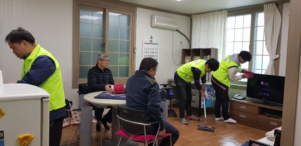 울진군선관위 직원과 공정선거지원단이 마을회관 실내를 쓸고 닦는 모습입니다.
